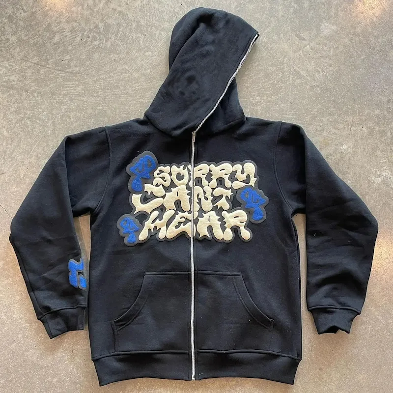 Black zip-up puff print hoodie with raised cream and blue lettering, made by Goodley Garments