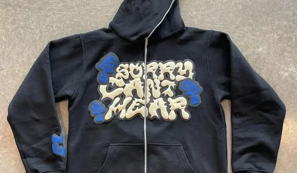 Black zip-up puff print hoodie with raised cream and blue lettering, made by Goodley Garments